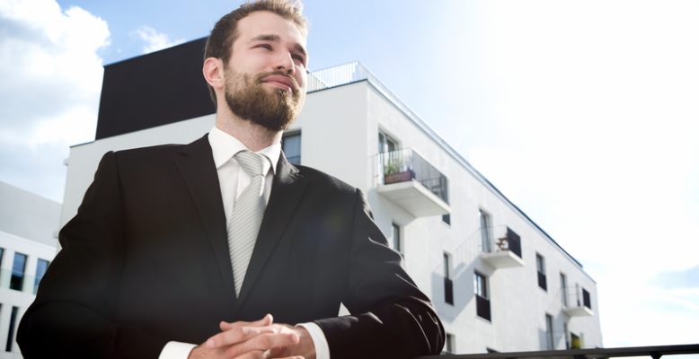 A property owner looks proudly at his building.