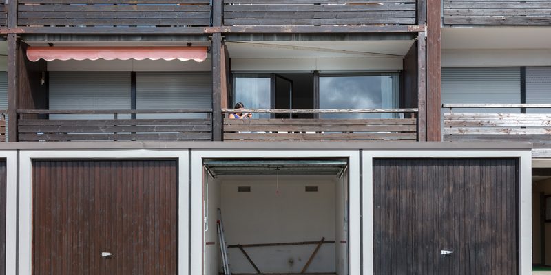 Old brown door of a garage, apartment complex
