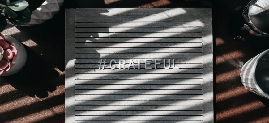 Grateful spelled out on a wooden plaque.