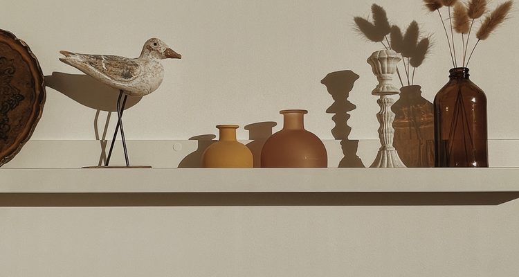 White,Decorated,Shelf,On,White,Wall,With,Sunlight,Shadows.,Aesthetic