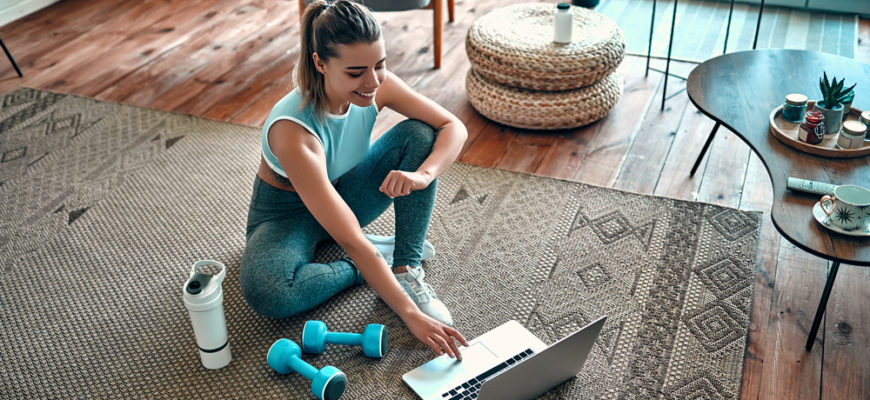 A,Sporty,Woman,In,Sportswear,Is,Sitting,On,The,Floor
