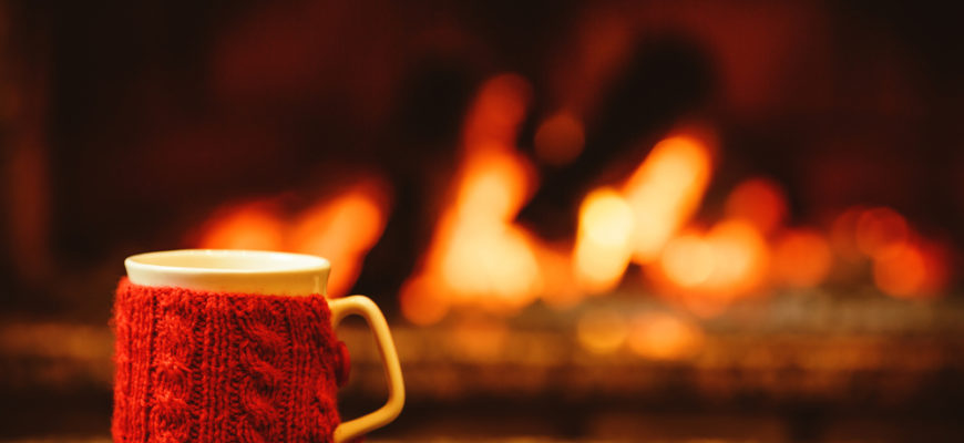 Cup,Of,Hot,Drink,In,Front,Of,Warm,Fireplace.,Holiday