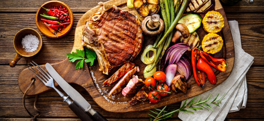 Beef,Steak,With,Grilled,Vegetables,And,Seasoning,On,Serving,Board