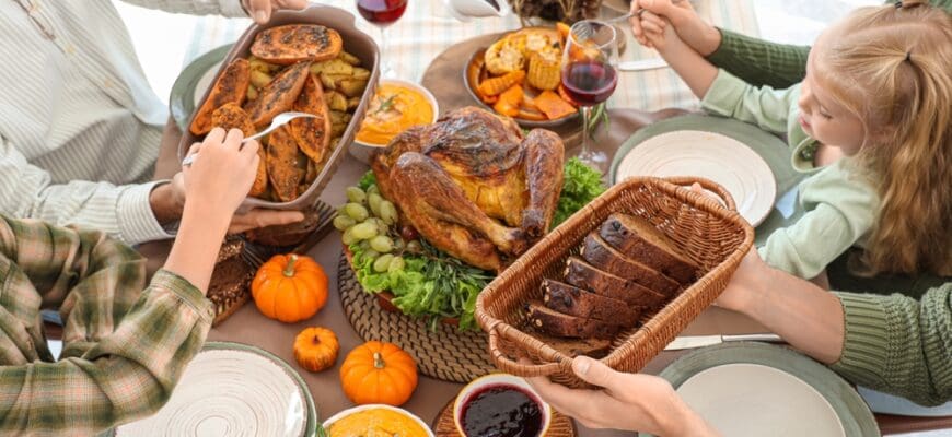 Happy,Family,Having,Dinner,At,Festive,Table,On,Thanksgiving,Day,