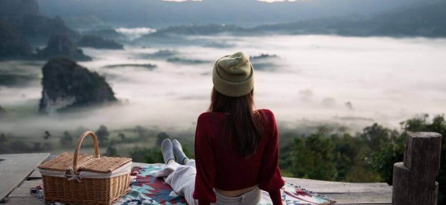 Solo,Traveler,Is,Relaxing,On,Balcony,Surrounded,By,Green,Forest
