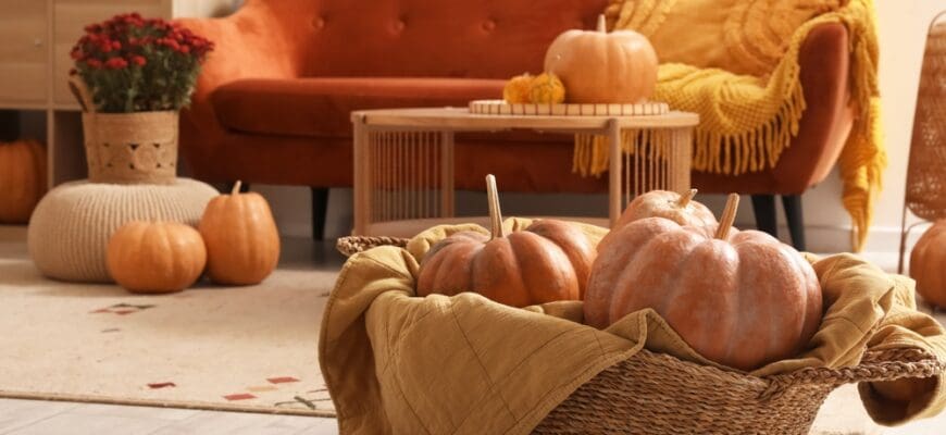 Wicker,Basket,With,Pumpkins,On,Floor,In,Living,Room,,Closeup