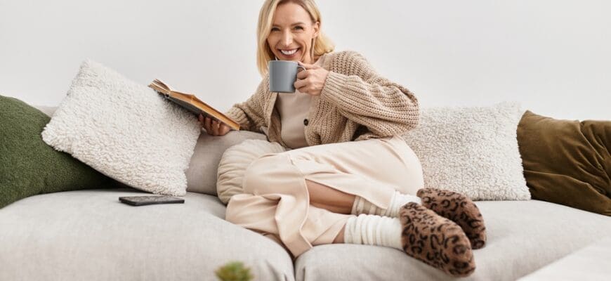 A,Relaxed,Blonde,Woman,Sips,Tea,While,Reading,A,Book